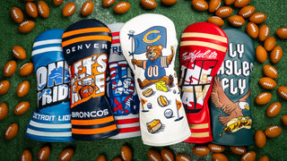 Collection of NFL sports team golf club headcovers on a grassy background with mini footballs.